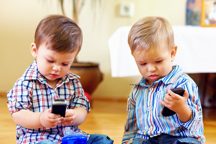 cute baby toddlers exploring mobile phones